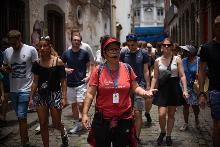Guide walking and explaining while the group follows.